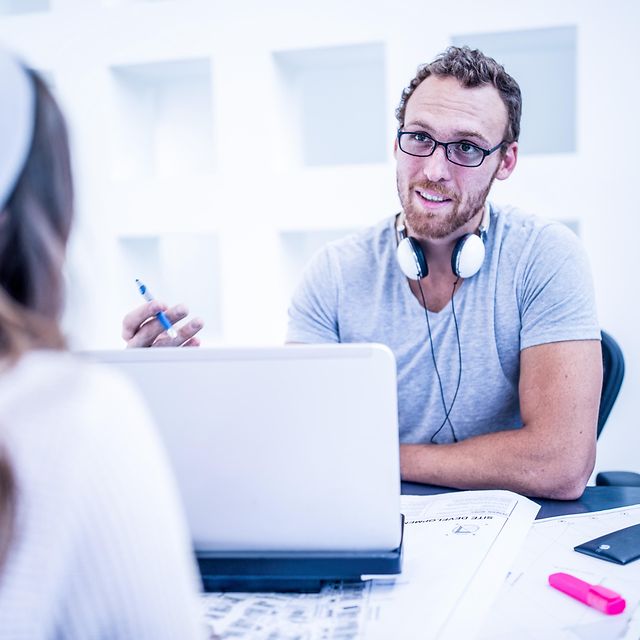 An employee advises a customer on Microsoft add-ons.