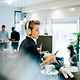 A woman from a team is on the phone in the office.