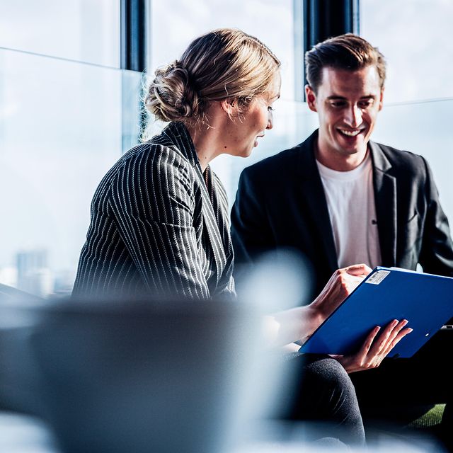 Group of two business people discussing the benefits of Microsoft Premium Services.