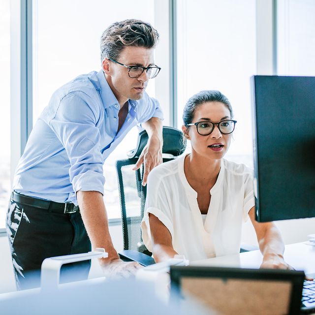 Two people looking at a computer screen