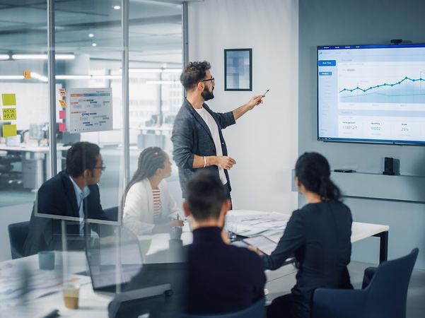 Motivated businessman leads a business meeting and used Microsoft Copilot to prepare for it.