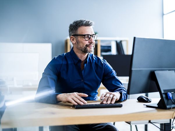 Businessman with business computer in office