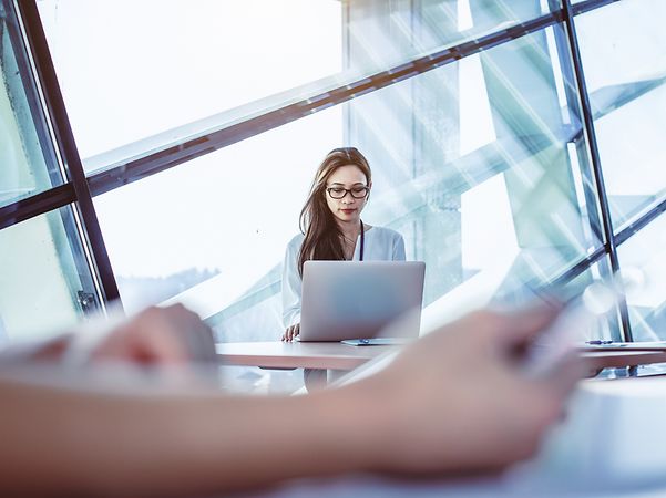 Young woman sitting in front of her laptop using ConnectWise Cloud Backup for her Microsoft 365 data.