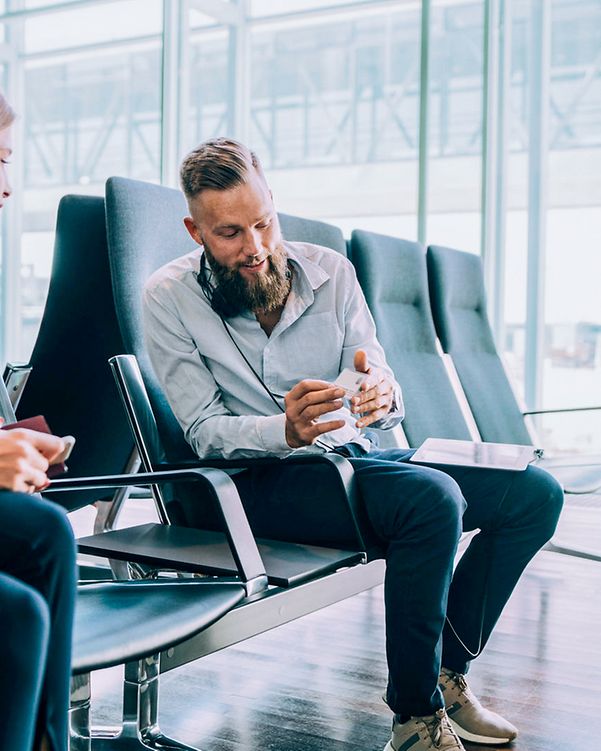 Man at the airport uses the mobile version of XPhone Connect.