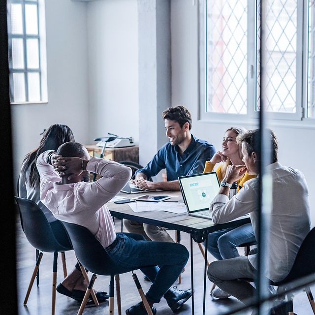 Colleagues at a conference table use XPhone Connect