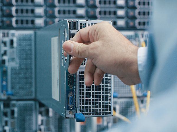 Recording of a man inspecting a hard drive in a data centre