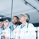 Several doctors stand in front of a planning board in a hospital, which is connected via 5G campus networks.