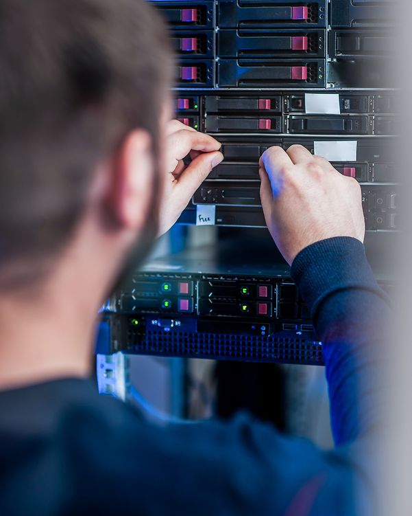 An employee configures settings on a server to scale the network using Cisco Meraki Managed Service.