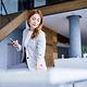 Businesswoman using a smartphone and working in a modern office.