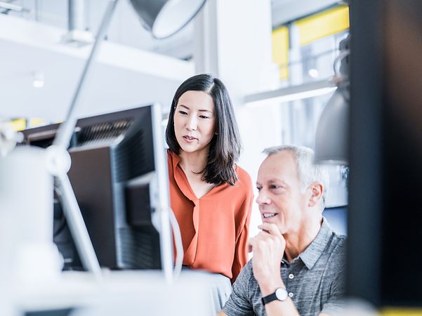 Two IT specialists are looking into UEM Managed Service for their company.