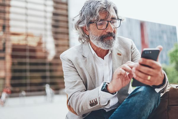 A man types on his mobile phone and books himself into Direct Numbering.