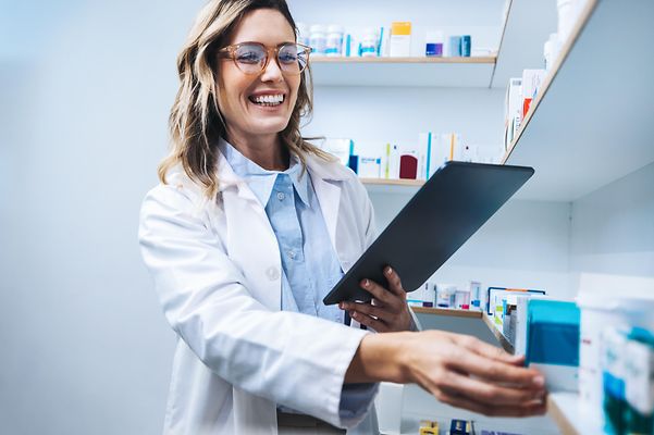 Telematics for pharmacies A pharmacist works on her tablet and searches for relevant medicines.