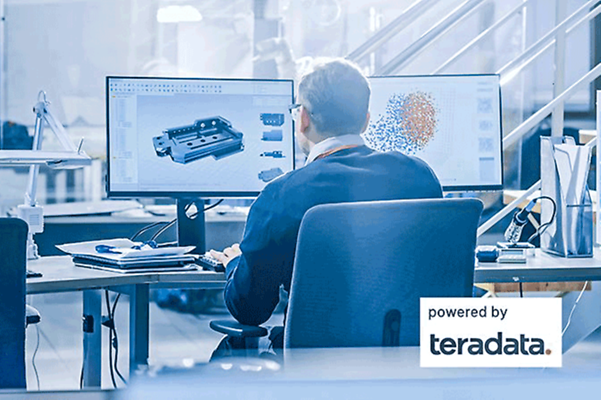 Man sitting in office in front of several screens using business analytics for production.