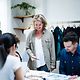 Business Analytics A team stands together in a clothing production facility