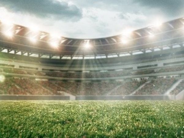 A stadium illuminated by floodlights.