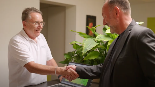 Two men shake hands