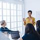 Female project manager in a meeting with her team in an office
