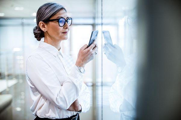 A woman holding a smartphone in her hand
