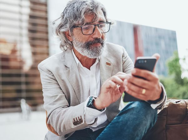 A man looks at his mobile phone.