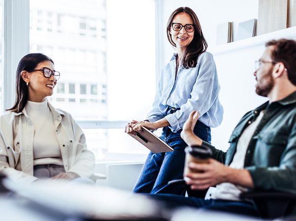 Two women and a man discuss Device as a Service for mobile devices in the company.