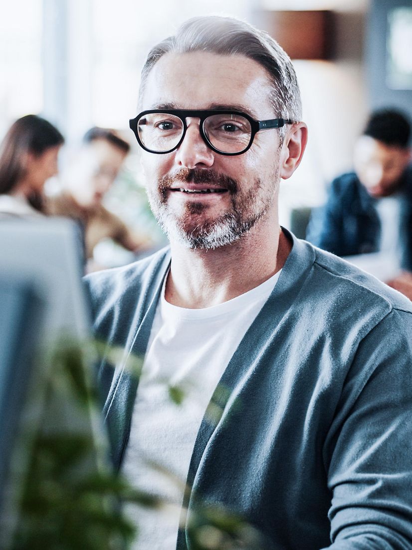 Man reading on screen about Device as a Service for businesses.