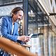 A smiling businessman is delighted with his company's dedicated internet access as he looks at his mobile phone.
