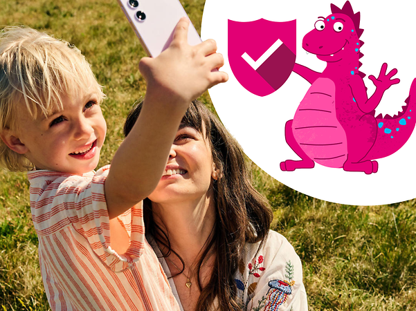 Smiling child with mobile phone next to mother and in front of them the dragon for safety from E.ON