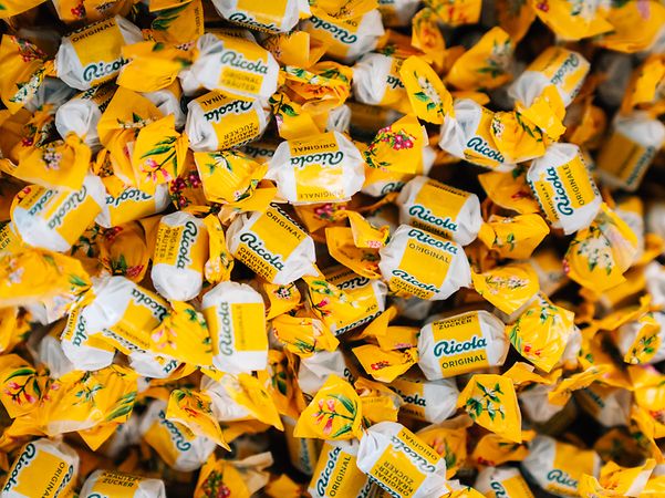 Lots of Ricola sweets wrapped in yellow paper.