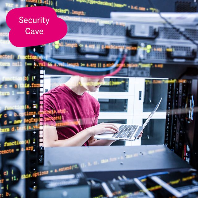 Person in the data centre working with a laptop between server cabinets, overlaid with programme code on the screen.