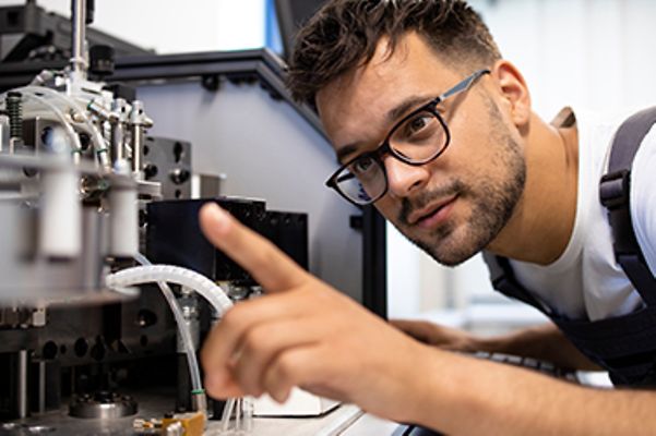 A skilled worker wearing smart glasses at a production facility