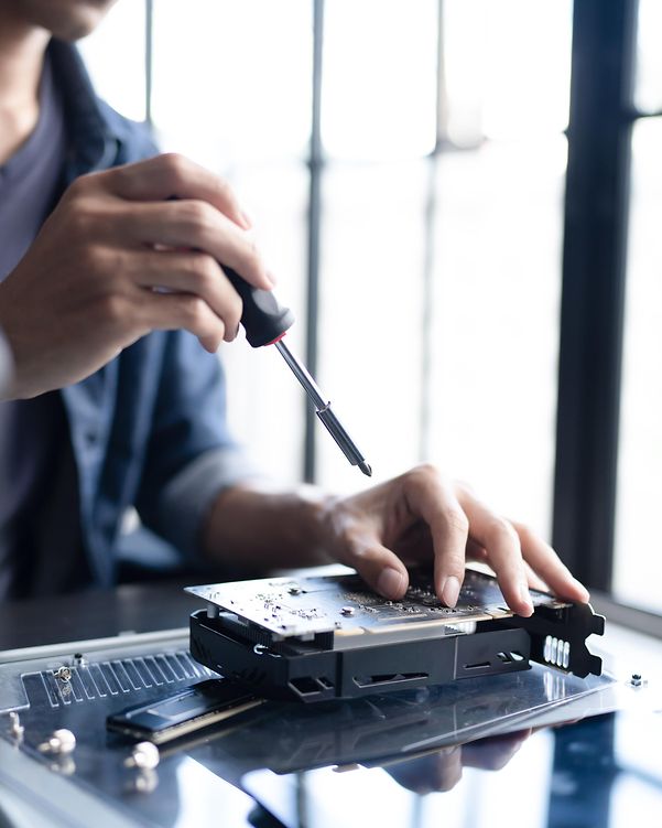 Ein Mann schraubt an einem Computerbauteil herum