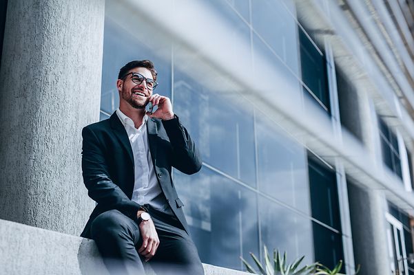 Ein lächelnder Geschäftsmann telefoniert über Microsoft Teams Telefonie