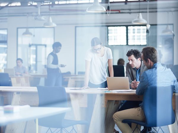 Mehrere Kollegen eines Startups diskutieren ihre Geschäftsidee.
