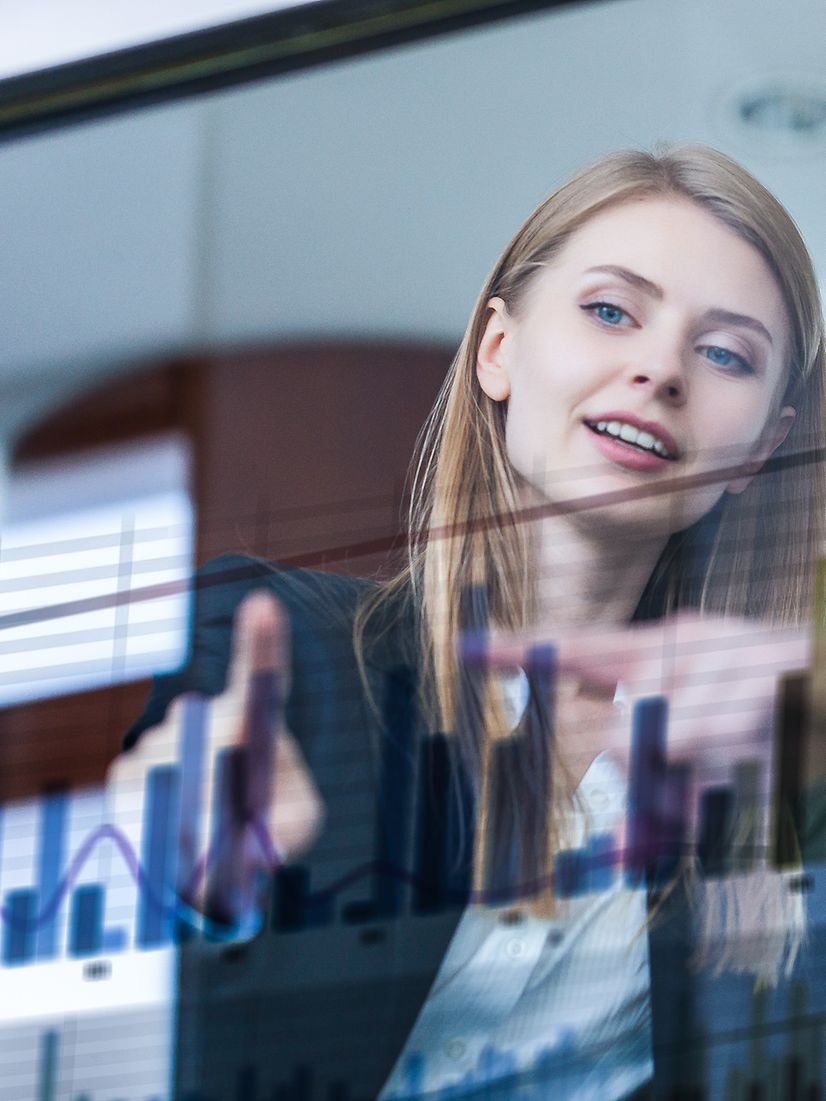Busienss Analytics Zwei Geschäftsleute vor futuristischem Display analysieren Daten