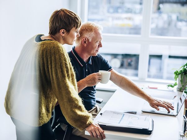 Mann und Frau besprechen sich im Büro am Computer