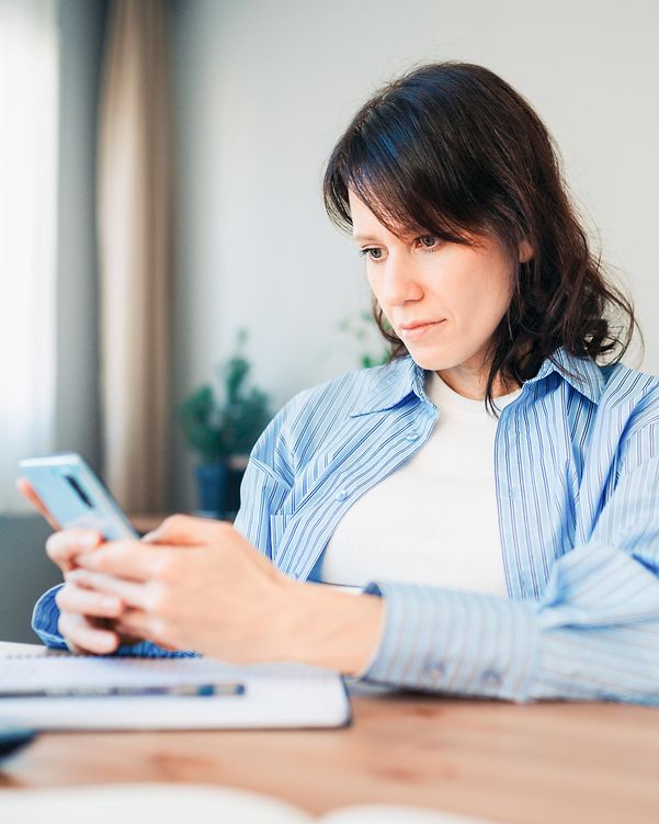 Eine Mitarbeiterin nutzt KI-Tools auf ihrem Smartphone, nachdem sie mit Digital Office Service KI-Support erhalten hat.